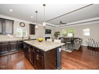 Modern kitchen featuring granite countertops, stainless steel appliances, and an open layout concept at 3029 Willow Ranch Dr, Fuquay Varina, NC 27526