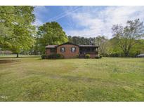 Charming single-story brick home with mature trees and a spacious front yard at 3121 Blue Hill Ln, Durham, NC 27703