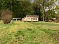 Quaint single Gathering home with covered parking and well-maintained lawn and natural surroundings at 335 Ashley Ave, Timberlake, NC 27583