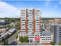 Modern high-rise building with red-brick accents and parking garage in a vibrant urban neighborhood at 400 W North St # 1420, Raleigh, NC 27603