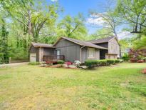 Charming two-story home with an attached garage, inviting porch, and front yard landscaping at 5816 Old Forge Cir, Raleigh, NC 27609