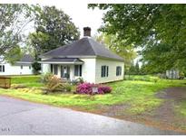 Charming single-story home with a cozy front porch and mature trees in a quiet neighborhood at 702 Mill St, Wake Forest, NC 27587