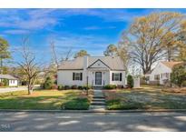 Charming home featuring a metal roof, landscaped yard, and inviting front entrance at 708 W Pope St, Dunn, NC 28334