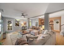 Bright and airy living room with plush seating, ceiling fan, and plenty of natural light at 725 Ancient Oaks Dr, Holly Springs, NC 27540