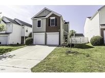 Charming two-story home featuring a well-manicured lawn and a two-car garage at 7528 Argent Valley Dr, Raleigh, NC 27616