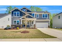 Charming two-story home featuring stone accents, neutral siding and a two car attached garage at 105 Scoville Rd, Garner, NC 27529