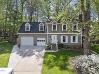 Traditional-style home features a two-car garage, dormer windows, and a well-manicured lawn at 108 Ridgepath Way, Cary, NC 27511