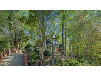 Charming brick home with lush greenery and a welcoming driveway at 108 Sierra Dr, Chapel Hill, NC 27514