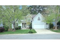 Charming two-story home with stone accents, lush landscaping, and a well-manicured lawn at 1120 Scholastic Cir, Durham, NC 27713