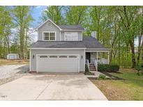 Charming two-story home with a well-maintained front yard, large garage, and inviting front porch at 120 Kerigon Ln, Youngsville, NC 27596