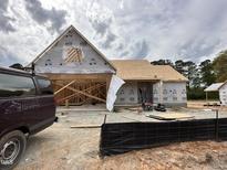 An exterior view of a home under construction, showing the framework and initial stages of development at 125 Tee Dr, Selma, NC 27576