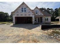New construction home featuring a two-car garage and partially completed front entrance at 125 Tee Dr, Selma, NC 27576