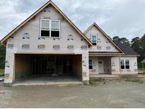 New construction home featuring an attached two-car garage and modern window styles at 125 Tee Dr, Selma, NC 27576