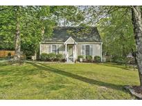 Charming single-story home with a manicured lawn and mature trees at 13816 N Meadows Ct, Wake Forest, NC 27587