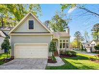 Charming home with a two-car garage and lovely landscaping at 1433 Deltona Dr, Raleigh, NC 27615