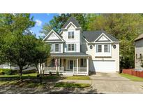Charming two-story home with a welcoming front porch and well-maintained landscaping at 1526 Town Home Dr, Apex, NC 27502