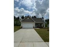 Charming one-story home featuring a spacious driveway, two-car garage, and well-maintained lawn and landscaping at 201 Benton Dr, Oxford, NC 27565