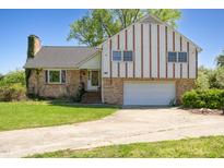 Charming two-story home featuring a brick facade and a spacious driveway leading to an attached garage at 2510 Poplar Creek Rd, Henderson, NC 27537