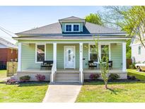 Charming home featuring a covered porch, light green siding, well-manicured lawn, and inviting curb appeal at 314 Bledsoe Ave, Raleigh, NC 27601