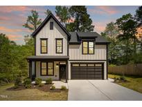 Two-story home featuring a modern farmhouse design with black trim and a two-car garage at 3221 Skycrest Dr, Raleigh, NC 27604