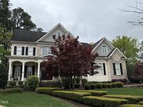 Charming home with stone and siding, front porch, a red maple tree, and manicured landscaping at 3300 Magical Pl, Raleigh, NC 27614