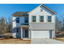 Charming two-story home with a two-car garage and a combination of vertical and horizontal siding at 79 Fern Ridge Dr, Cameron, NC 28326