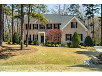 Traditional brick home with manicured lawn and landscaping at 83 Calabria Ct, Clayton, NC 27527