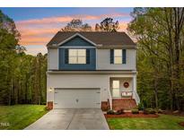 Charming two-story home with a front-facing garage and welcoming front porch at 10 Shearin Ln, Youngsville, NC 27596