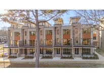 Modern townhome exterior features a brick facade, private balconies, and sleek, contemporary design at 1010 Manor Way, Durham, NC 27701