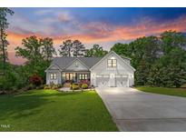 Charming two-story farmhouse with landscaped yard and a three-car garage at 1506 Gormly Cir, Sanford, NC 27330