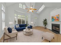 Bright living room with vaulted ceilings, fireplace, and large windows at 1640 Legendary Ln, Morrisville, NC 27560