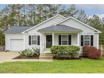 Charming single-story home with a well-manicured lawn, flowering bushes and beautiful xeriscaping at 225 Lodestone Dr, Durham, NC 27703