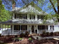 Charming two-story home with a spacious front porch, black shutters and landscaped front yard at 2385 Olde Spring Ct, Graham, NC 27253