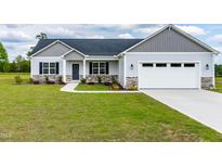 Charming single-Gathering home with a well-manicured lawn, two-car garage, and stone accents at 241 Indigo St, Lillington, NC 27546