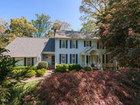 Charming two-story home with light blue siding, dark shutters, and well-manicured landscaping at 3320 Marblehead Ln, Raleigh, NC 27612