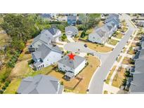 Beautiful aerial view of a neighborhood street, with a house featuring a fenced yard and screened in porch at 408 Torwood Cir, Apex, NC 27523
