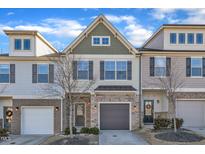 Charming multi-level townhome with inviting curb appeal and attached one car garage at 518 Retreat Ln, Wake Forest, NC 27587
