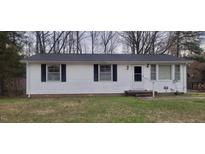 Charming single-story home with white siding, black shutters, and a well-maintained front lawn at 530 Broad Rd, Roxboro, NC 27573