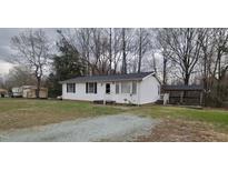 Charming single-story home with a well-maintained white exterior and a cozy covered gazebo in the backyard at 530 Broad Rd, Roxboro, NC 27573