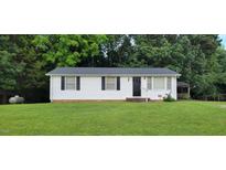 Charming one-story home featuring classic black shutters and a lush green front lawn at 530 Broad Rd, Roxboro, NC 27573