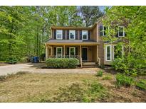 Charming two-story home featuring a welcoming front porch and well-maintained landscaping at 5610 Frenchmans Creek Dr, Durham, NC 27713