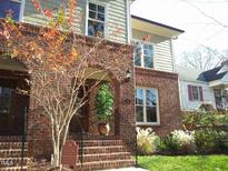 Brick front entrance with beautiful autumn colors, arched doorway, and wrought iron railing at 714 Mordecai Towne Pl, Raleigh, NC 27604