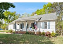 Charming one-story home with a welcoming front porch and an American flag, perfect for suburban living at 807 Clean View Ct, Fuquay Varina, NC 27526
