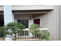 Condo entrance featuring a red door, partial porch, and visible unit number for easy identification at 811 New Kent Pl # 1A, Cary, NC 27511
