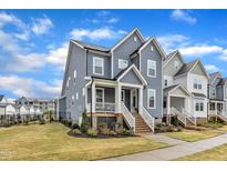 Charming two-story home featuring a welcoming front porch and well-maintained landscaping at 1136 Remey Ave, Wake Forest, NC 27587