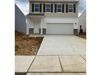 Charming two-story home featuring a large two car garage and concrete driveway at 133 N Keatts Winner Ct, Wilson's Mills, NC 27520