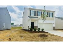 Charming two-story home featuring a two-car garage, manicured landscaping, and a welcoming front entrance at 133 N Keatts Winner Ct, Wilson's Mills, NC 27520