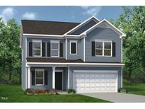 Charming two-story home featuring blue siding, black shutters, and a well-manicured lawn with colorful flower beds at 143 Mildred Place, Broadway, NC 27505