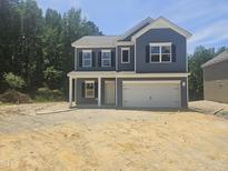 Two story home with blue siding, black shutters and a two car garage at 143 Mildred Place, Broadway, NC 27505