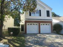 Charming two-story home with a two-car garage and brick accents on the front at 1613 Beacon Valley Dr, Raleigh, NC 27604